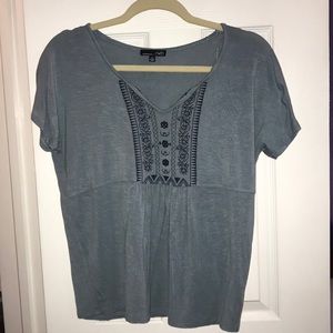 Light blue top with navy embroidering.